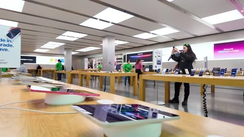 Apple store interior, computers, staff, customers, consumer electronics, iphones Stock Footage 307874232