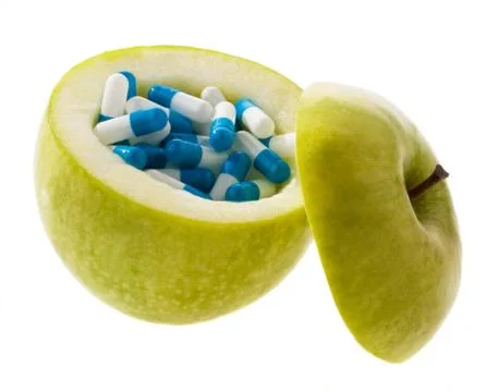 Apple with tablets capsules. Stock Photos