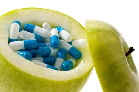 Apple with tablets capsules. Stock Photos
