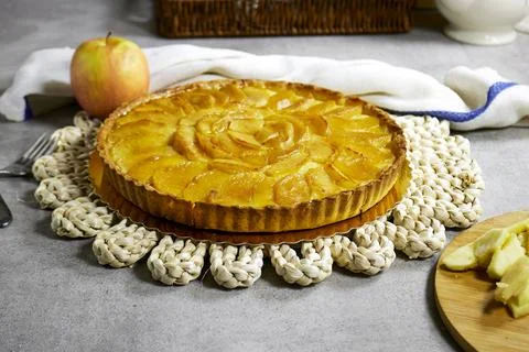 Apple Tart Pie Centered on Rustic Plaited Doily with Fresh Apple Slices and Cutl Stock Photos