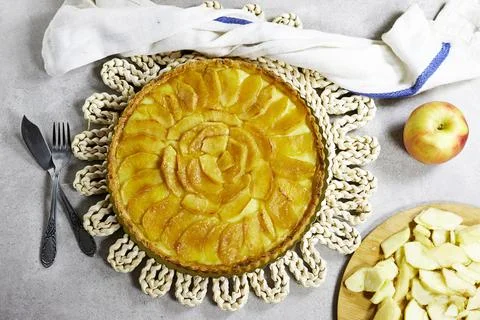 Apple Tart Pie Centered on Rustic Plaited Doily with Fresh Apple Slices and Cutl Stock Photos