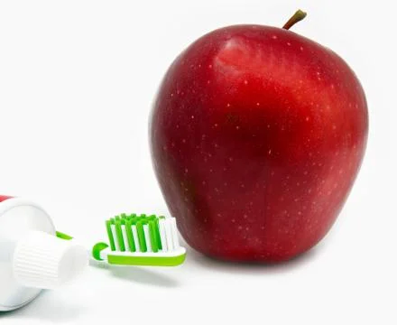 Apple, thothbrush, toothpaste on white Stock Photos