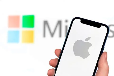 Apple vs microsoft concept. Mobile phone with logo on the screen, close-up vi Stock Photos
