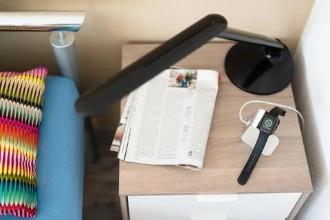 Apple Watch being charged on the bedside table Stock Photos