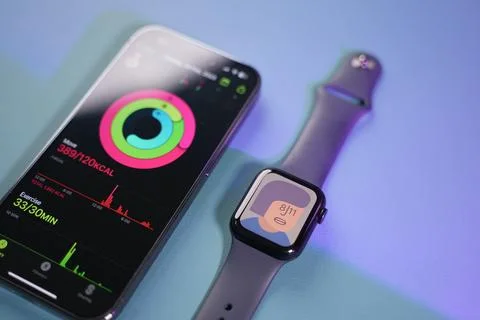 An apple Watch beside an iPhone Stock Photos