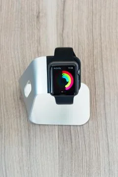 Apple watch in stand displaying mediocre daily activities Stock Photos
