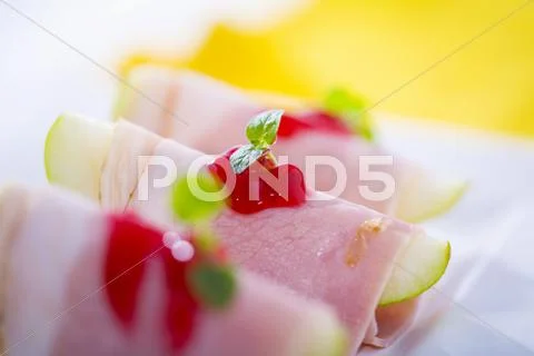 Apple wedges wrapped in ham with cranberry jam Stock Photos