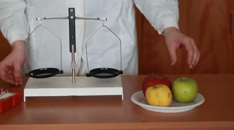 Apple weighing in the balance Stock Footage 48681987