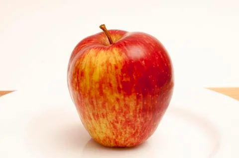 Apple on a white plate Stock Photos