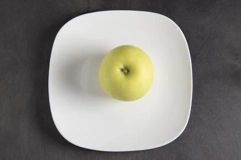Apple on a white plate Stock Photos