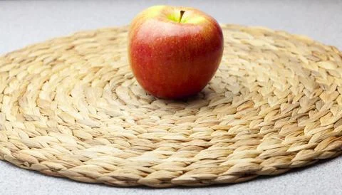 Apple on a wicker mat Stock Photos