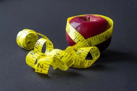 The apple is wrapped with a centimeter tape Stock Photos