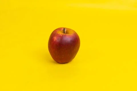 An apple on yellow background Stock Photos