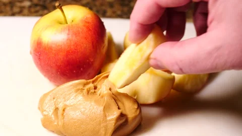 Apples and peanut butter on white plate eating fresh healthy Stock Footage 234589402