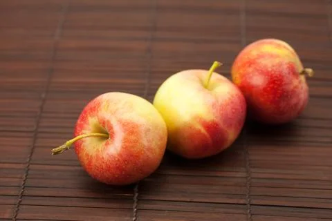 Apples on a bamboo mat Stock Photos