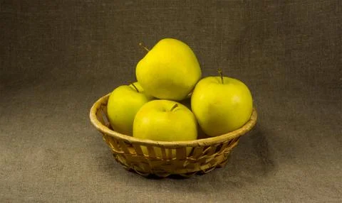 Apples in a basket on a background of burlap Stock Photos