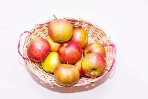 Apples in a basket on a white background close up Stock Photos