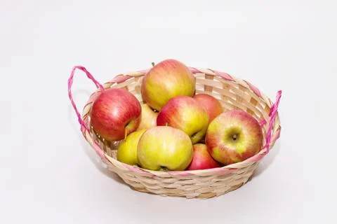 Apples in a basket on a white background close up Stock Photos