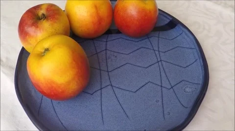 Apples on a blue plate Stock Footage 45864211