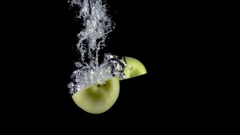 Apples fall in water. Slow motion 500fps Stock Footage 128832554