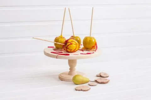 Apples in glaze on wooden stand Stock Photos