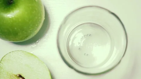 Apples green top view slow motion poured juice Stock Footage 72179145