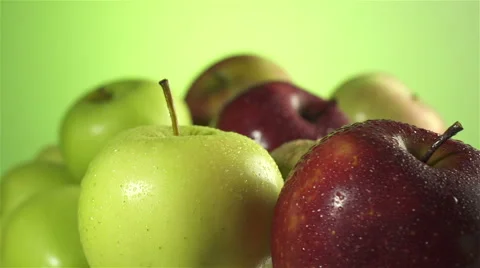 Apples isolated rotating on green background Stock Footage 62344219