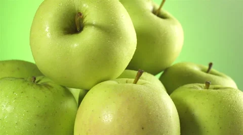 Apples isolated rotating on green background Stock Footage 62414678