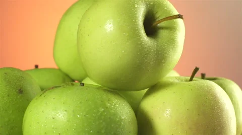 Apples isolated rotating on orange/brown background Stock Footage 62414798