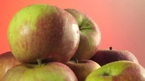 Apples isolated rotating on red background Video stock 62393644
