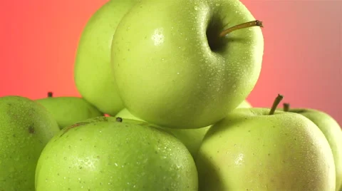 Apples isolated rotating on red background Видео 62414708