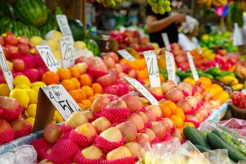 Apples, lemons, oranges, and cucumbers at vibrant fruit stall in Philippines Stock Photos