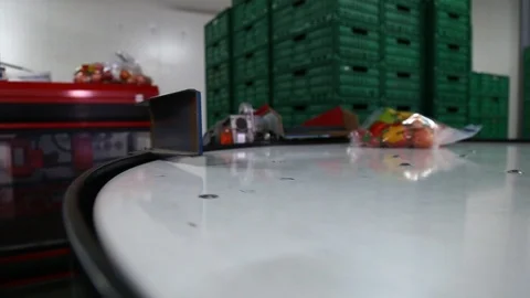 Apples packed in a plastic bag move along the conveyor. Stockbeeldmateriaal 125663478