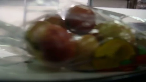 Apples packed in a plastic bag move along the conveyor. Stockbeeldmateriaal 125663996