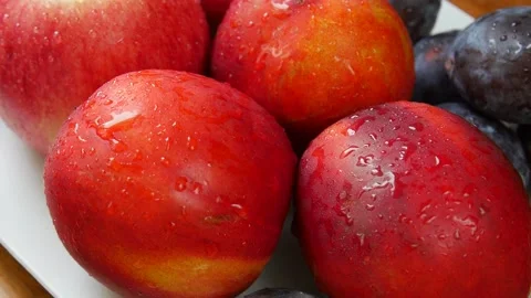 Apples, peaches and plums on a plate. Stock Footage 328403274
