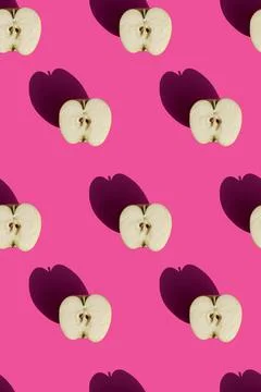 Apples on pink background pattern Stock Photos
