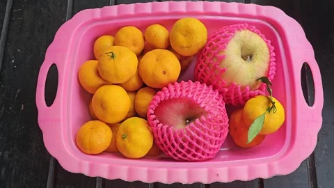 Apples in Pink Foam Nets and Mandarins in a Pink Plastic Tray Vídeos de archivo 332027704