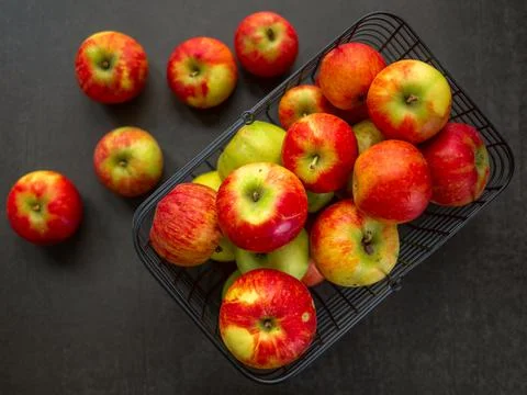 Apples, red, in a wire basket. Stock Photos