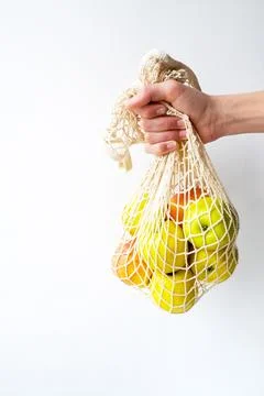 Apples in a string bag in hand. Natural fresh organic fruits. food diet. Stock Photos