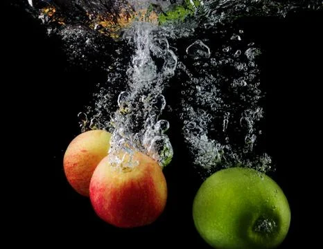 Apples in water Stock Photos