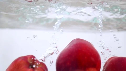 Apples in water in slow motion Stock Footage 76041001