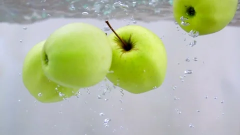 Apples in water in slow motion Stock Footage 76041041