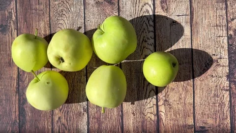 Apples on a wooden surface Stock Footage 247932588