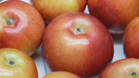 Apples on a wooden table. Camera slowly turns around the fruit. Stock Footage 106722783