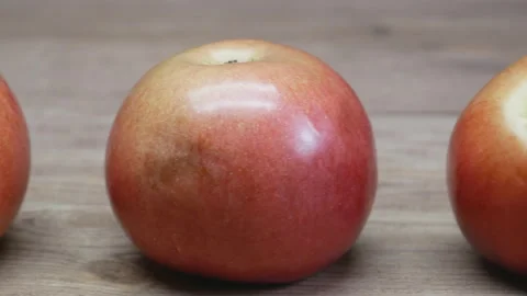 Apples on a wooden table. Camera slowly moves from right to left. Stock Footage 106724392