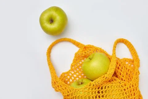 Apples in a yellow string bag. The zero waste concept, top view. Stock Photos