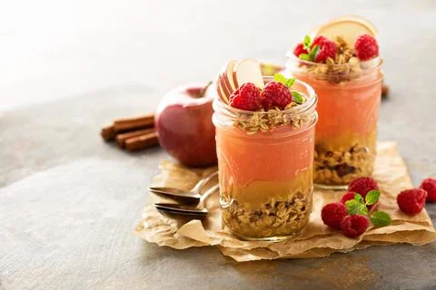 Applesauce and raspberry puree parfait with granola Stock Photos