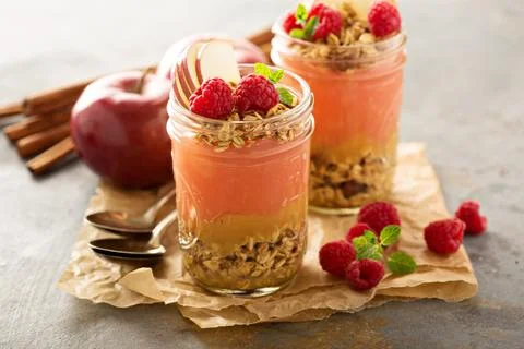 Applesauce and raspberry puree parfait with granola Stock Photos