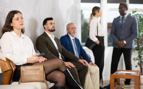 Applicants are waiting for interview, there is queue of people sitting in Stock Photos