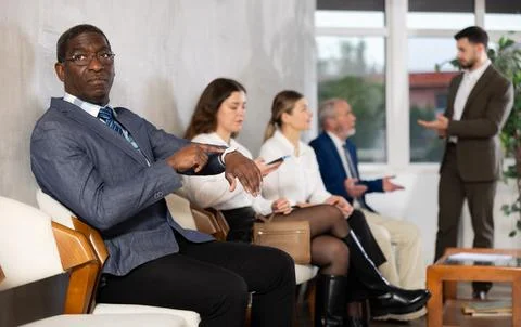 Applicants are waiting for interview, there is queue of people sitting in Stock Photos